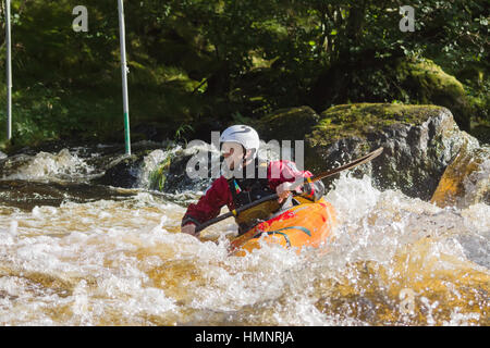 White water canoeist competing in the Canoe Wales National Slalom at the National White Water Centre Stock Photo