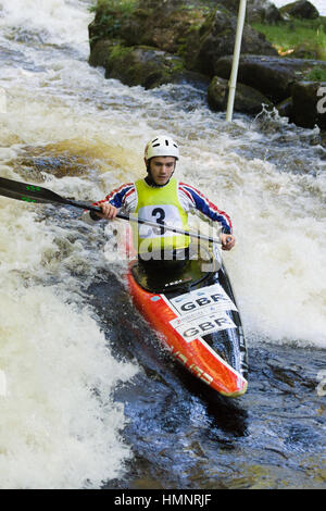White water canoeist competing in the Canoe Wales National Slalom at the National White Water Centre Stock Photo