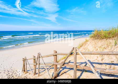 Wooden fence of entrance to sandy Bialogora beach, Baltic Sea, Poland Stock Photo