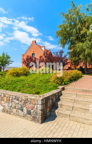 Typical red brick house in green park in Hel town, Baltic Sea, Poland Stock Photo