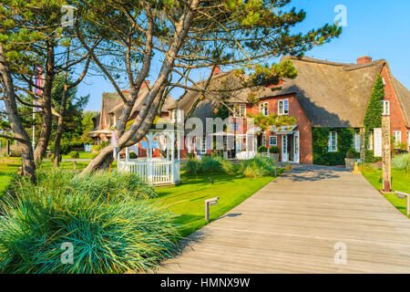 SYLT ISLAND, GERMANY - SEP 6, 2016: typical Frisian houses and shops with thatched roofs in Kampen village on Sylt island, Germany. Stock Photo