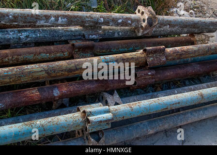 old rusty blue metal pile of pipes Stock Photo