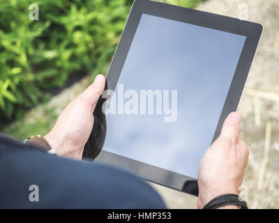 Closeup of Man's hands using Digital Tablet Stock Photo