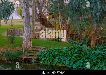 Steps leading from the river banks to a dreamy backyard of country house Stock Photo