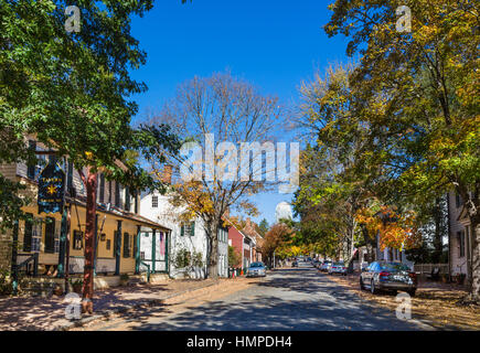 Old Salem. Main Street in Old Salem with Wells Fargo Center tower in downtown in the distance and tavern to left, Winston-Salem, North Carolina, USA Stock Photo