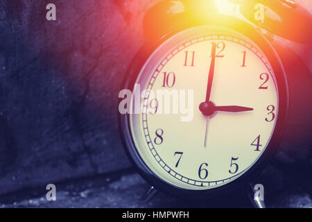 3 o'clock vintage clock at dark color tone with sun light memory time concept. Stock Photo