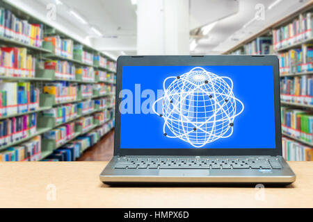 Laptop with blank screen on table with blur bookshelf at libraly Education and technology concept. Stock Photo