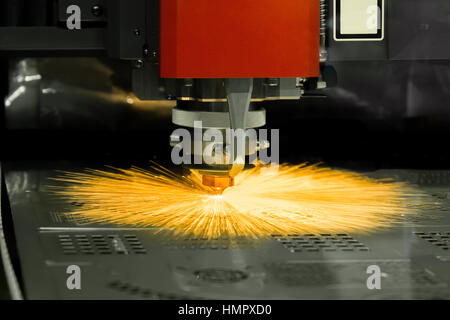High precision CNC laser cutting metal sheet in factory. Stock Photo