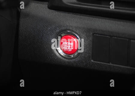 Detail close up of red engine start stop car button in modern car. Stock Photo