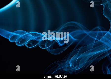 blue curly smoke lines isolated on black Stock Photo