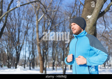 young man running in winter Stock Photo