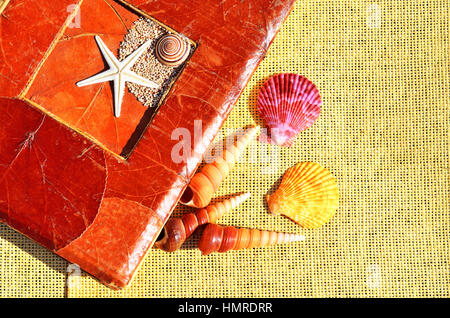 Old-fashioned album, colored seashells on the sacking Stock Photo