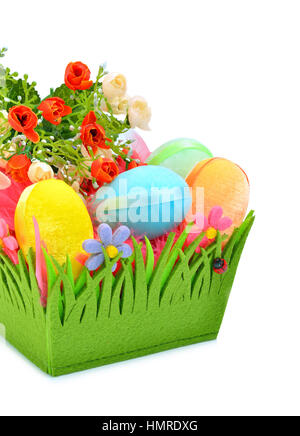 Easter colored cloth eggs, roses in the flowerbed isolated on the white background Stock Photo