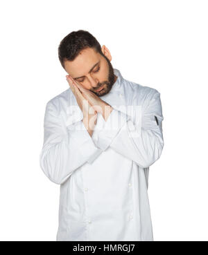 Young Chef sleeping in white uniform isolated on white background. Stock Photo