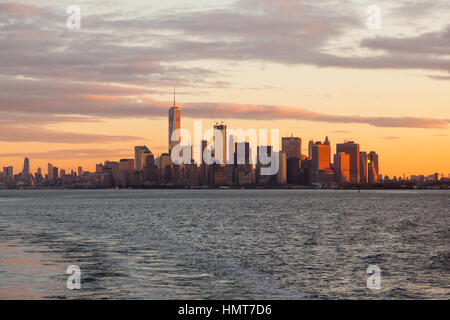 Manhattan island at dawn photographed from the Staten island Ferry, New York City, United States of America. Stock Photo