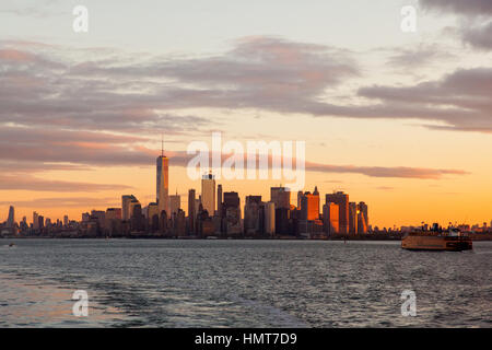 Manhattan island at dawn photographed from the Staten island Ferry, New York City, United States of America. Stock Photo