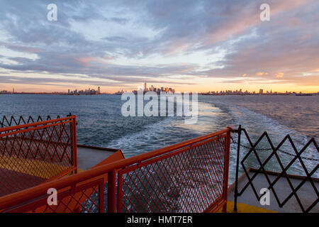 Manhattan island at dawn photographed from the Staten island Ferry, New York City, United States of America. Stock Photo