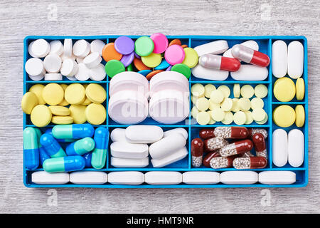 Pills and capsules in container. Stock Photo