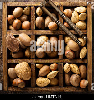 Various nuts in shell in a wooden box Stock Photo