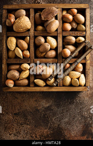 Various nuts in shell in a wooden box Stock Photo