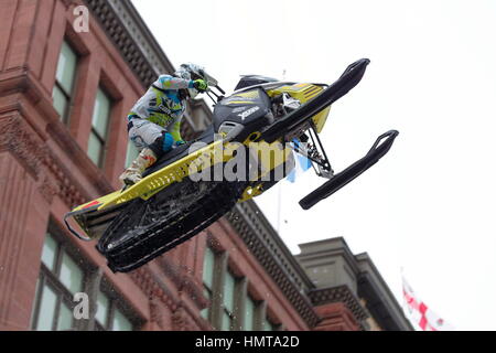 World snowmobiling champions perform aerial jumps above Ste-Catherine street in downtown Montreal Stock Photo