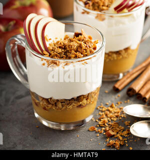 Layered yogurt and applesauce parfait with granola Stock Photo