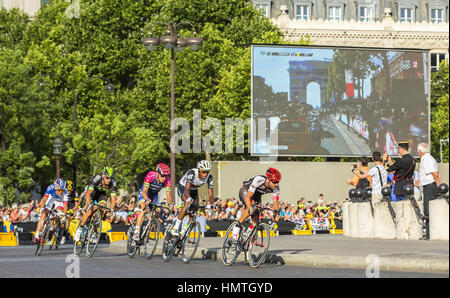 Paris, France - July 24, 2016: The breakaway passing by the Arch de Triomphe on Champs Elysees in Paris during the latest stage of Tour de France 2016 Stock Photo