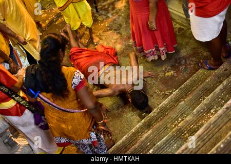 Kuala Lumpur, Malaysia. 04th Feb, 2017. Hindus devotees possessed by the god reacts in a state of trance as he's heading to the Batu caves in Kuala Lumpur, Malaysia on February 04, 2017. To mark this day, Hindus devotees pierce different part of their body with various metal skewers and carry pots of milk on their heads along couple of kilometers to celebrate the honor of Lord Subramaniam (Lord Murugan) in the Batu Caves, one of the most popular shrine outside India and the focal point to celebrate the Thaipusam Festival in Malaysia. Thaipusam is an annual Hindu festival, observed on the day o Stock Photo