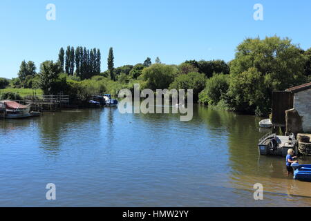 River Frome at Wareham Abbotts Quay on a hot summers day with boats and people..Holiday staycation Sunday outing. Boat hire Stock Photo