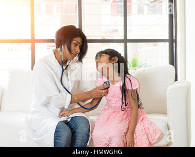 indian female doctor treating young girl patient Stock Photo - Alamy