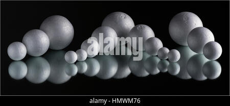 Polystyrene balls placed on a mirror. Yongnuo 560III flash in a 60x60cm softbox with grid, camera right. Sat level and slightly forward as not to ligh Stock Photo