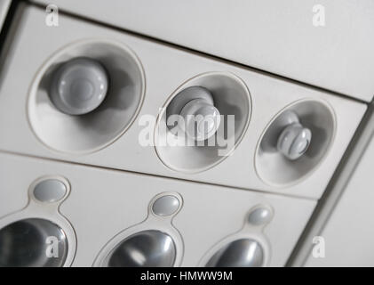 lights, air condition signs panel above the seat on plane Stock Photo