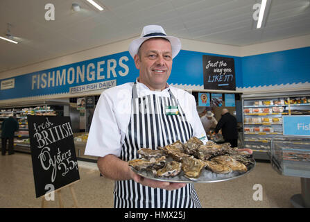 EDITORIAL USE ONLY Morrisons' seafood specialist Andrew Speight prepares oysters for customers at Morrisons in Bradford as the supermarket chain reduces the cost of oysters, a known aphrodisiac, to 25p for Valentine's Day. Stock Photo