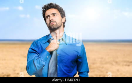 Sweating businessman due to hot climate Stock Photo