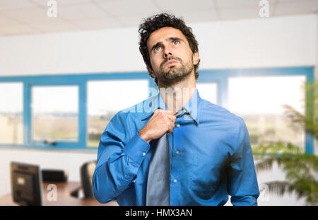 Sweating businessman due to hot climate Stock Photo