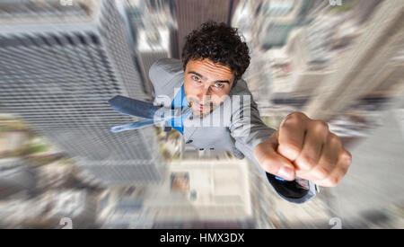 Businessman superhero flying above a city Stock Photo