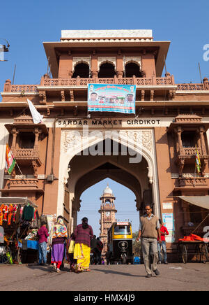 JODHPUR, INDIA - JANUARY 20, 2015 : People and rickshaws using the entrance gate to Girdikot and Sardar Markets. Jodhpur's famous clock tower can be s Stock Photo