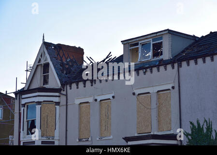 Fire-damaged roofs on a street in Middlesbrough also showing the houses boarded up and in a state of dereliction Stock Photo