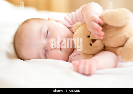 infant baby sleeping with plush toy Stock Photo