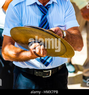 musician plays the cymbals during a religious procession Stock Photo