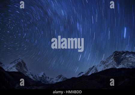 star trails from a long exposure over the Himalayan mountains of Pumori Lingtren Khumbutse and Nuptse from near Lobuche Stock Photo