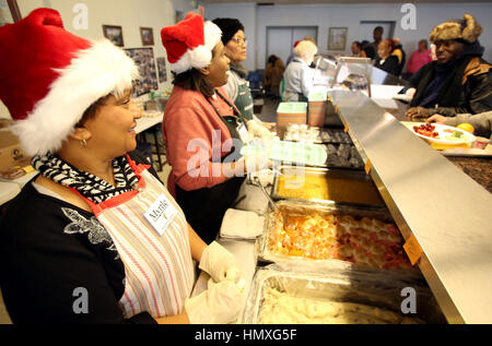 Davenport, Iowa, USA. 16th Dec, 2016. Volunteer Myrtle Graves, left helps serve the noon meal to dozens of people at the at King's Harvest shelter and meal site on West 3rd Street in Davenport Friday, December 16, 2016. Credit: Kevin E. Schmidt/Quad-City Times/ZUMA Wire/Alamy Live News Stock Photo