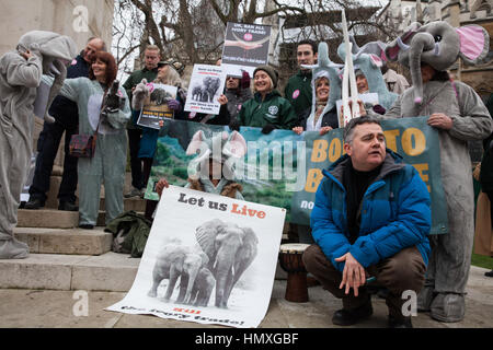 London, UK. 6th February, 2017. Dominic Dyer (r) poses with animal rights campaigners, some of whom dressed as elephants, taking part in a peaceful gathering outside Parliament to support the debate on the UK ivory ban. Credit: Mark Kerrison/Alamy Live News Stock Photo