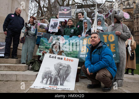 London, UK. 6th February, 2017. Dominic Dyer (r) poses with animal rights campaigners, some of whom dressed as elephants, taking part in a peaceful gathering outside Parliament to support the debate on the UK ivory ban. Credit: Mark Kerrison/Alamy Live News Stock Photo