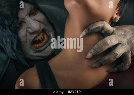 Scary vampire devil biting young woman. Medieval gothic nightmare horror. Studio shoot Stock Photo