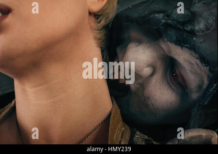 Scary vampire devil biting young woman. Medieval gothic nightmare horror. Studio shoot Stock Photo