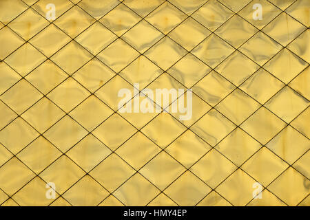 Golden metal shiny vivid rooftop tile panels texture background Stock Photo