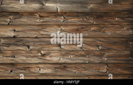 Brown old vintage knotty wooden wide planks wall background texture with aged dark gray and black grunge woodgrain pattern Stock Photo