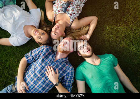 Happy young people on ground smiling and having fun Stock Photo