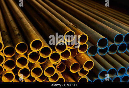 yellow and blue metal pipes in warehouse Stock Photo